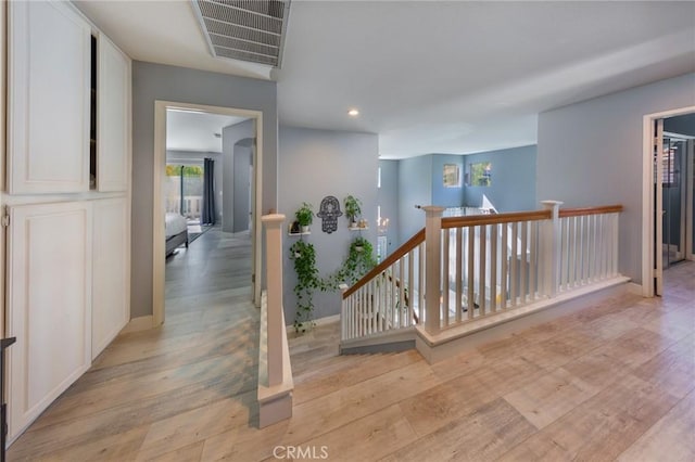 corridor with light hardwood / wood-style floors