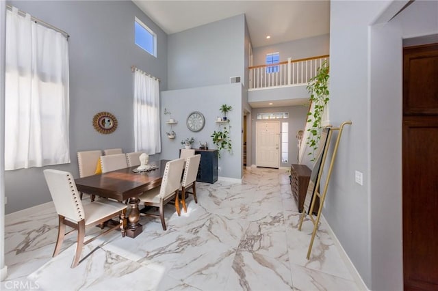 dining space featuring a high ceiling