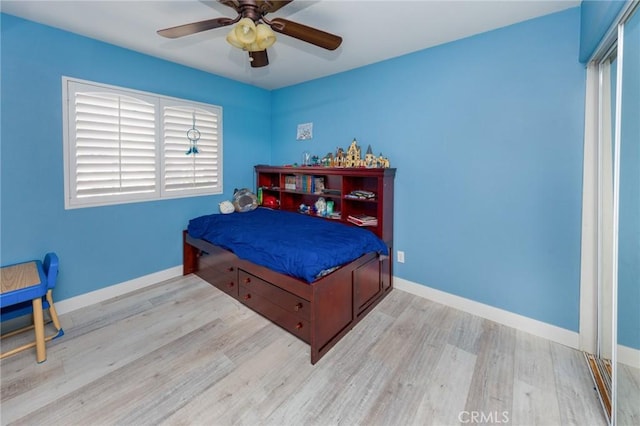 bedroom with ceiling fan and light hardwood / wood-style flooring