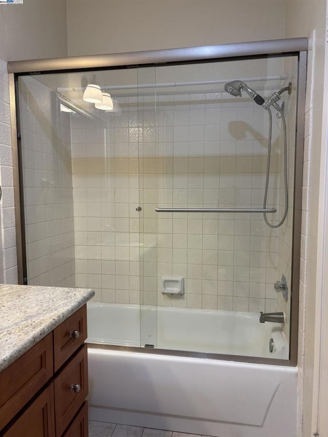 bathroom with vanity and enclosed tub / shower combo