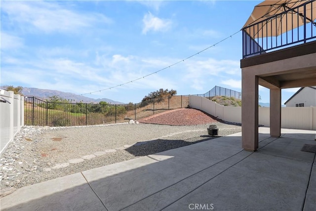 view of yard featuring a mountain view and a patio area