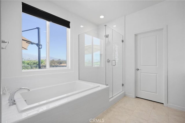 bathroom featuring tile patterned floors and shower with separate bathtub