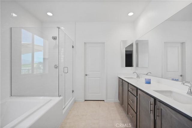 bathroom with tile patterned floors, vanity, and plus walk in shower