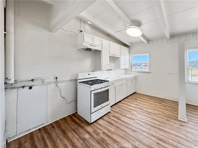 kitchen featuring custom range hood, a healthy amount of sunlight, white cabinetry, and white range with gas cooktop