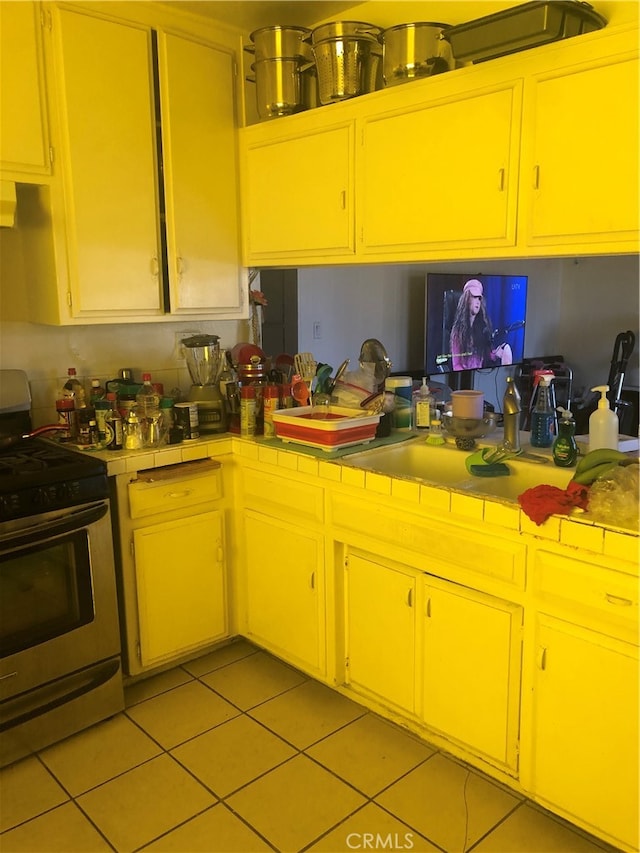 kitchen featuring stainless steel range and light tile patterned floors