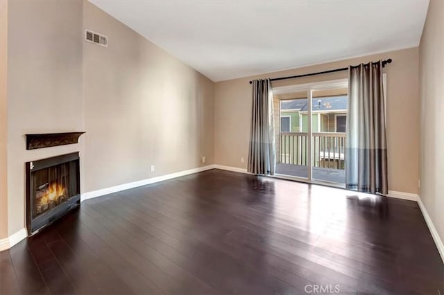 23556 Cambridge Rd Unit 327, Yorba Linda, CA 92887 - unfurnished living room featuring baseboards, dark wood-type flooring, a warm lit fireplace, and visible vents