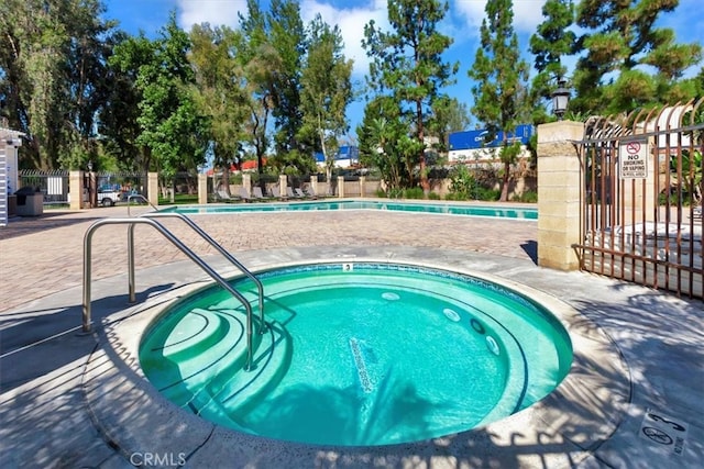 view of swimming pool featuring a community hot tub