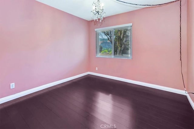 23556 Cambridge Rd Unit 327, Yorba Linda, CA 92887 - unfurnished room with baseboards, dark wood-style floors, and a chandelier