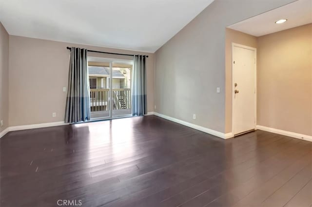 spare room featuring dark wood-type flooring