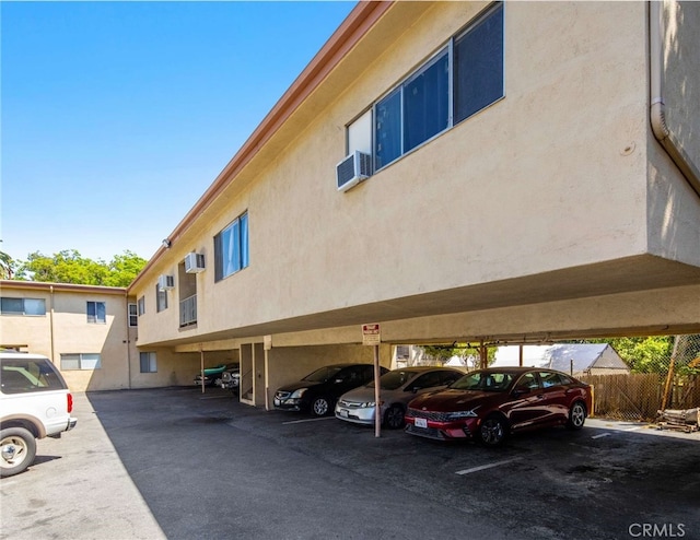 view of building exterior featuring cooling unit and a wall mounted AC