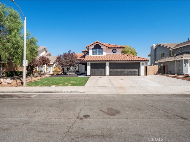 mediterranean / spanish-style home with a front yard and a garage