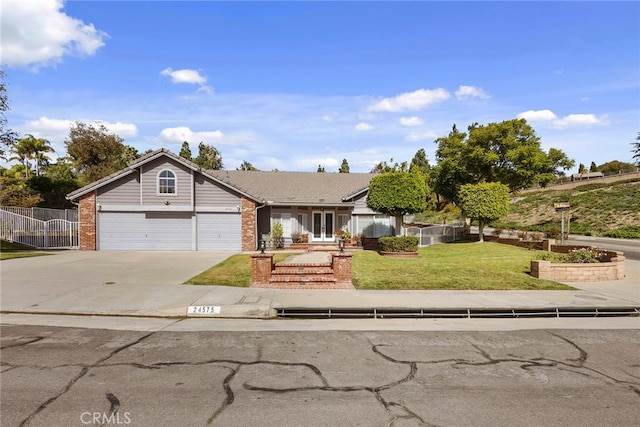 view of front of house with a garage and a front lawn