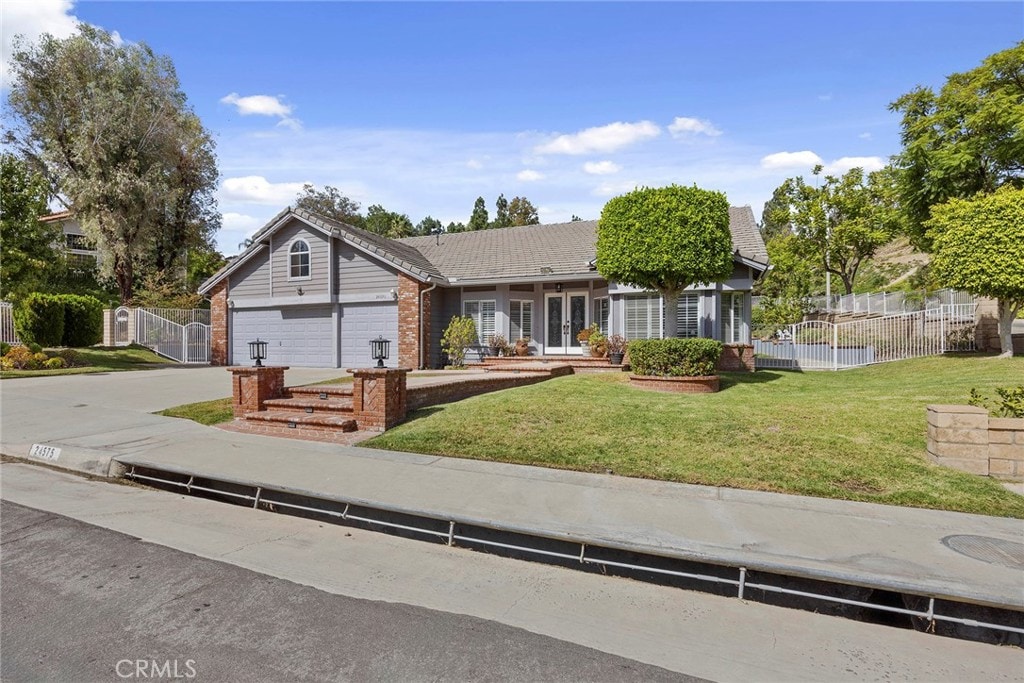 view of front facade with a front lawn and a garage