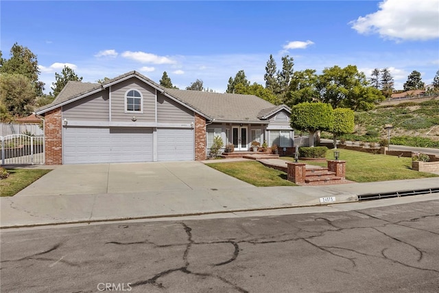 view of front of property with a front yard and a garage