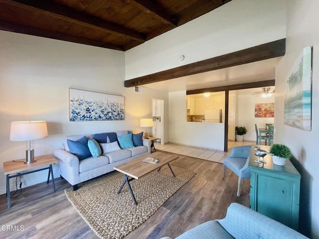 living room with hardwood / wood-style flooring, ceiling fan, beamed ceiling, and wood ceiling