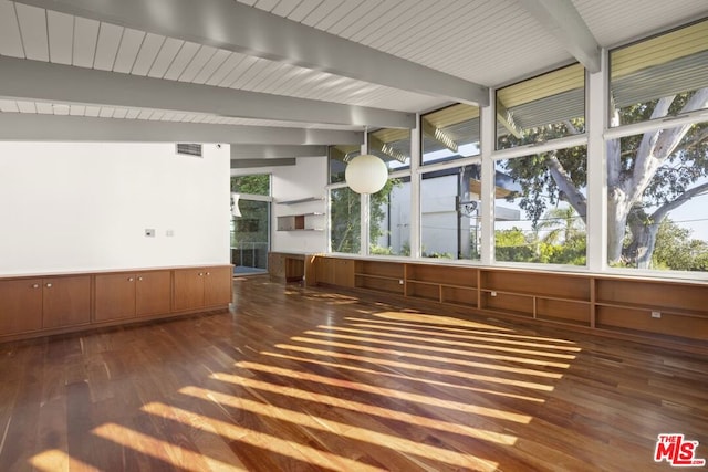 unfurnished sunroom with beamed ceiling and a wealth of natural light