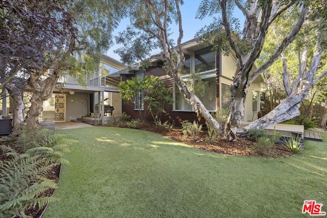 view of yard with a patio area and a balcony