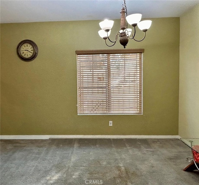 unfurnished dining area with a chandelier and carpet flooring