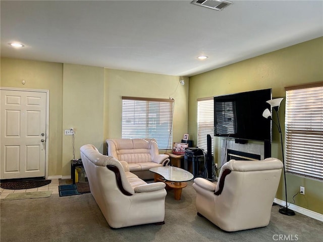 carpeted living room featuring a fireplace