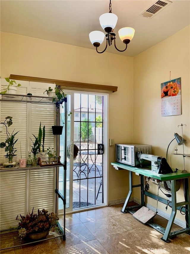 doorway to outside with a chandelier