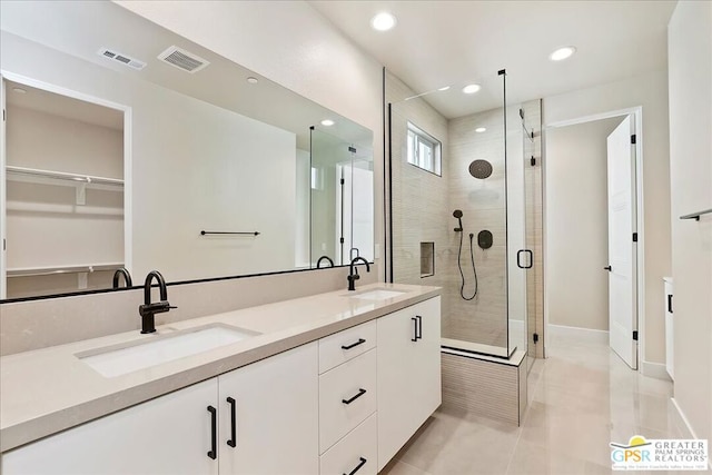 bathroom with vanity, tile patterned flooring, and an enclosed shower