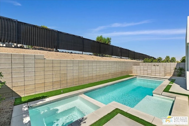 view of swimming pool with an in ground hot tub