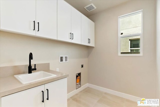 laundry room with light tile patterned flooring, cabinets, hookup for an electric dryer, hookup for a washing machine, and sink