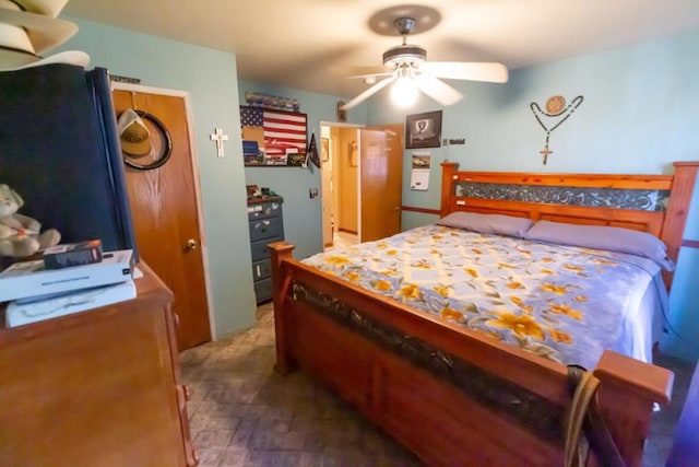 bedroom with dark wood-type flooring and ceiling fan