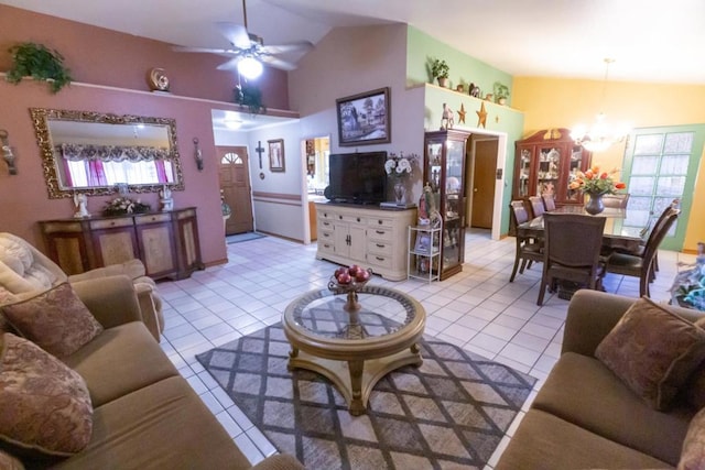 tiled living room with vaulted ceiling and ceiling fan with notable chandelier