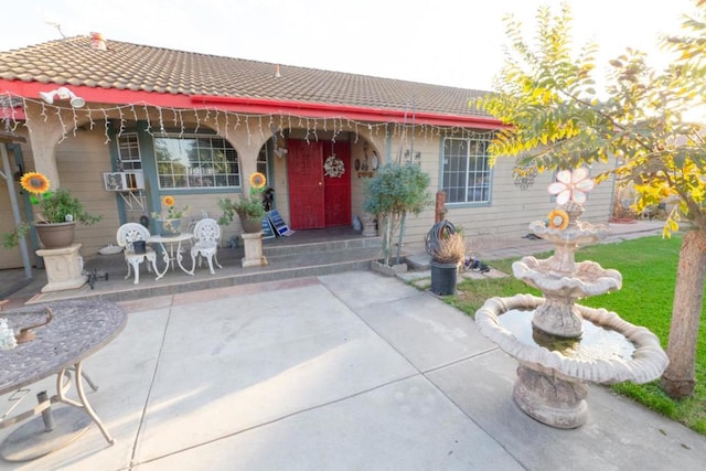 property entrance featuring a patio area