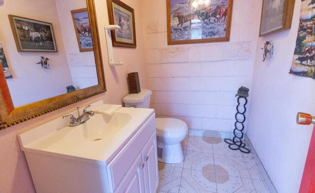 bathroom with vanity, toilet, and tile patterned flooring