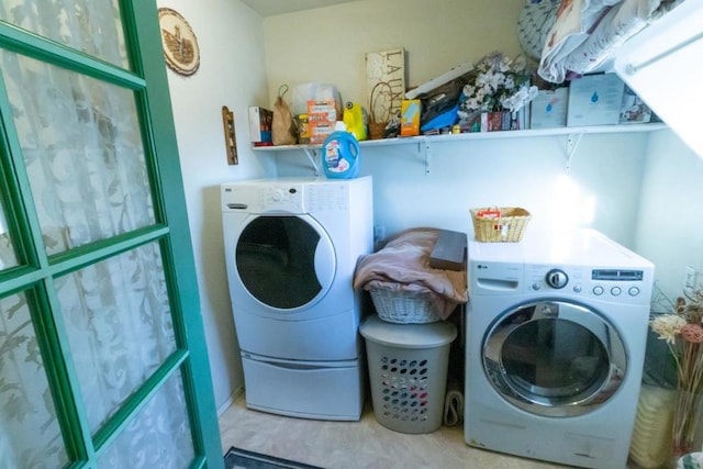 washroom with washing machine and clothes dryer