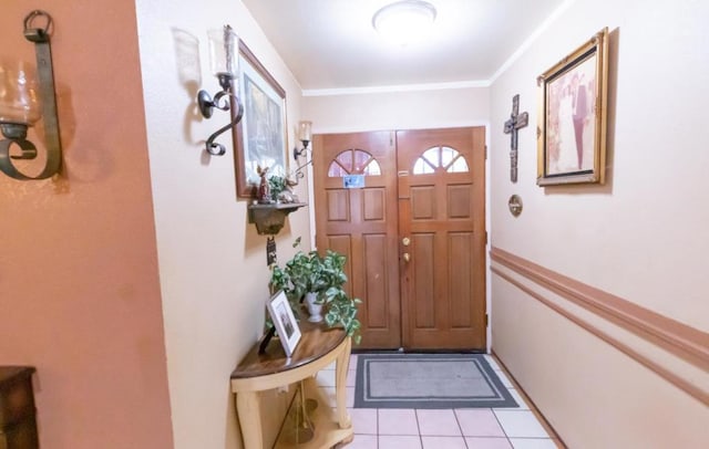 doorway to outside featuring crown molding and light tile patterned floors