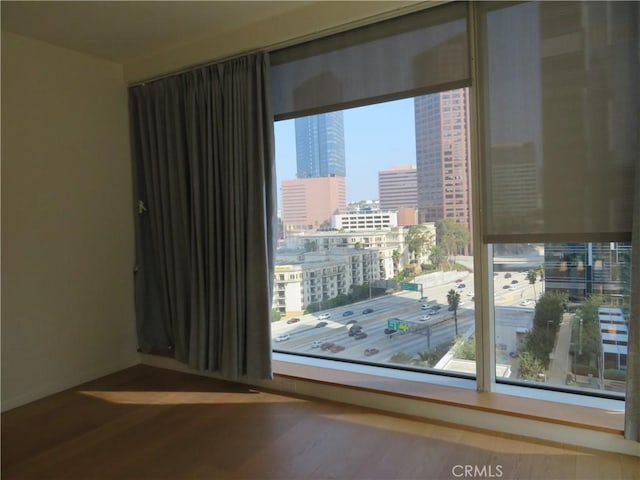 889 Francisco St Unit 1609, Los Angeles, CA 90017 - empty room with a view of city, wood finished floors, and baseboards
