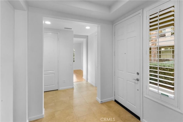 entrance foyer featuring light tile patterned floors, visible vents, baseboards, and recessed lighting