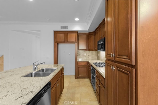 kitchen featuring stainless steel appliances, a sink, visible vents, ornamental molding, and light stone countertops