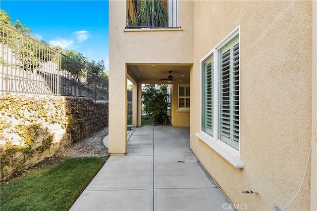 exterior space featuring ceiling fan and fence