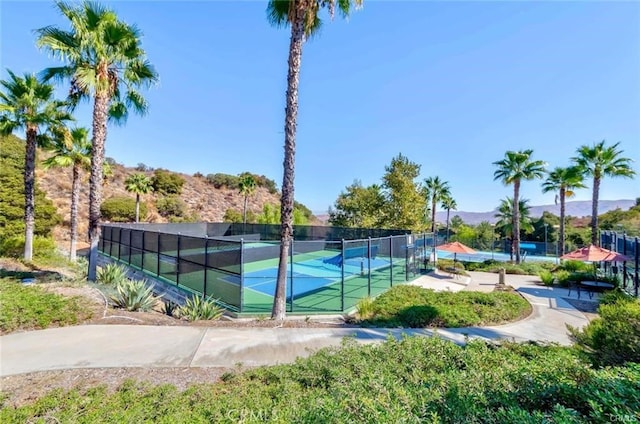 view of sport court featuring fence