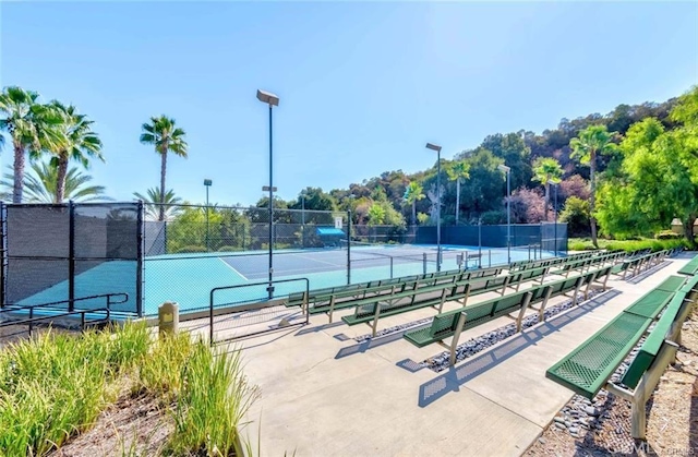 view of tennis court featuring fence