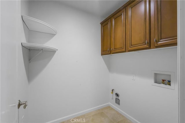 washroom featuring cabinet space, baseboards, gas dryer hookup, hookup for a washing machine, and hookup for an electric dryer