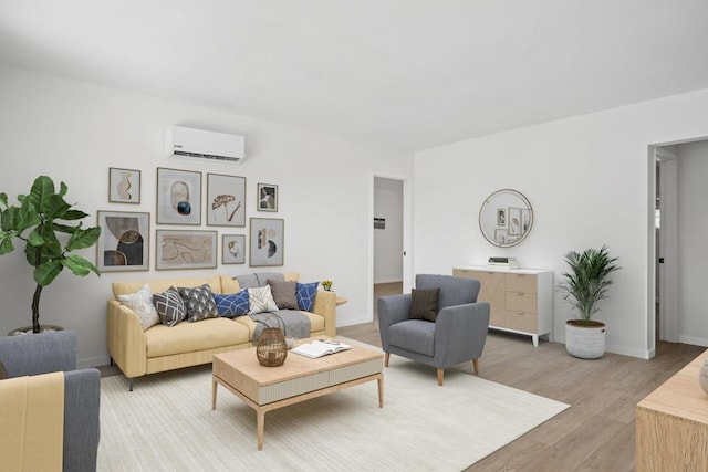 living room featuring an AC wall unit and light wood-type flooring