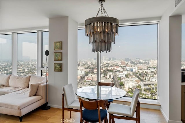 dining space featuring a notable chandelier and light hardwood / wood-style flooring