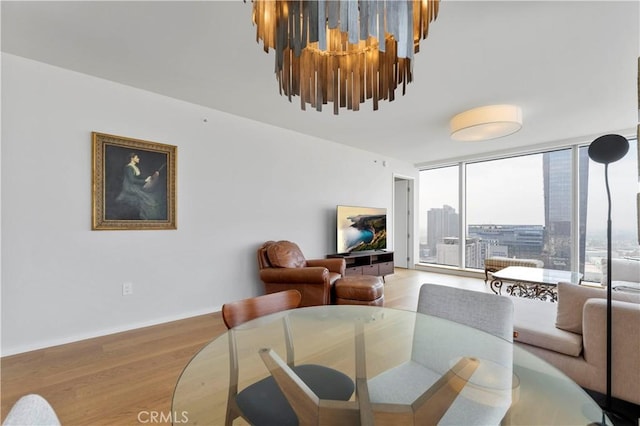 dining space featuring light hardwood / wood-style floors and a notable chandelier