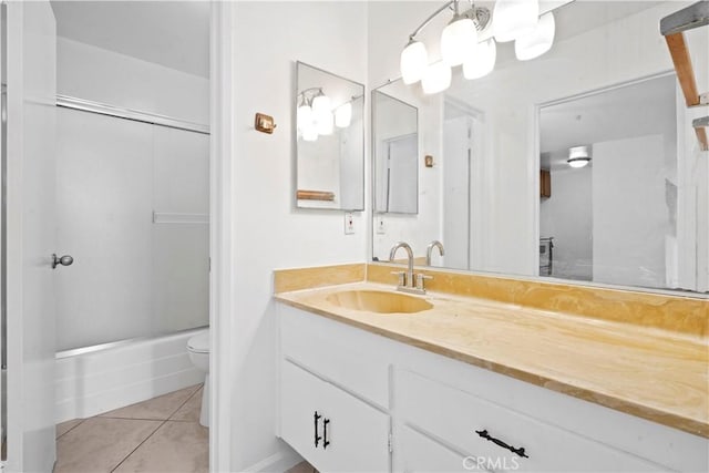 full bathroom featuring toilet, combined bath / shower with glass door, tile patterned floors, and vanity