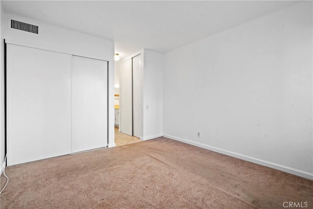 unfurnished bedroom with light colored carpet