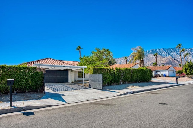 view of front of property featuring a mountain view and a garage