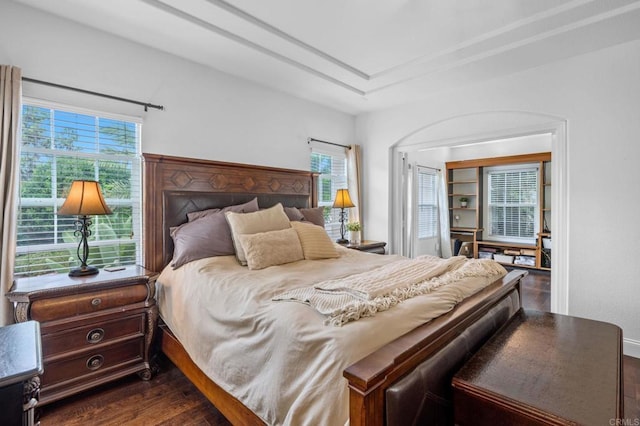 bedroom with dark hardwood / wood-style floors