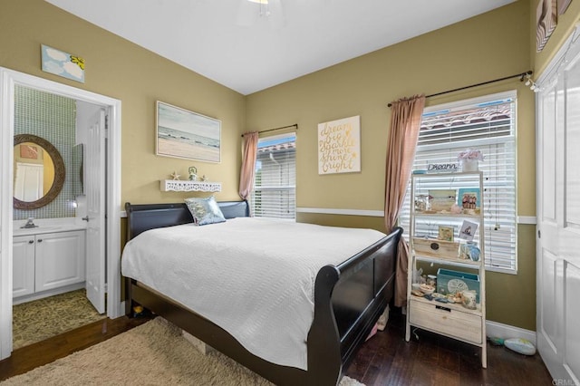 bedroom featuring dark hardwood / wood-style flooring and ensuite bath