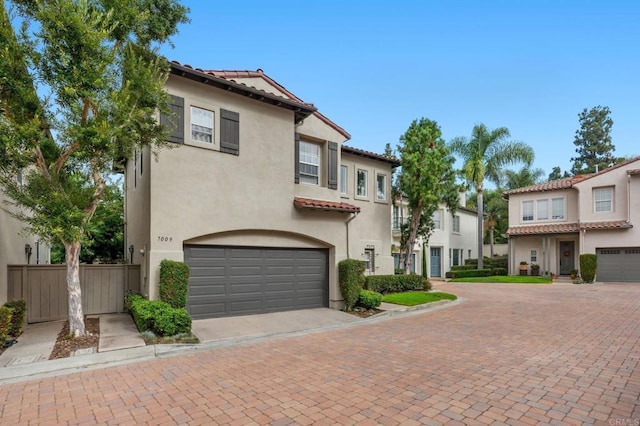 mediterranean / spanish-style home with a garage