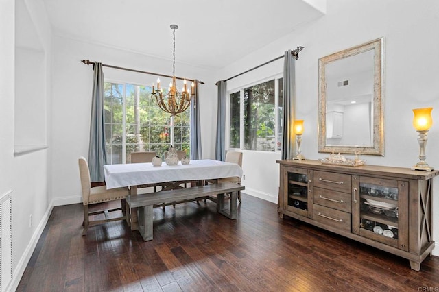 dining area with plenty of natural light, dark hardwood / wood-style flooring, and a chandelier